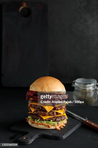 close-up of burger on table - burger close up stock pictures, royalty-free photos & images