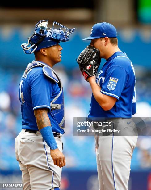 Catcher Salvador Perez of the Kansas City Royals talks to pitcher Brad Keller in the second inning during a MLB game against the Toronto Blue Jays at...