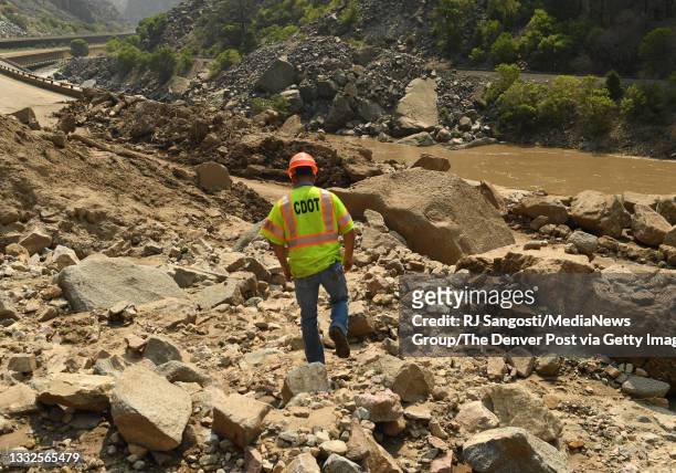 Chuck Decker, of the Colorado Department of Transportation, checks out the damage on I-70 in Glenwood Canyon after the interstate closed due to...