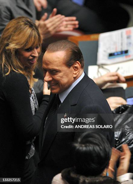 Italy's former Prime minister and head of the Popola della liberta party's group at the lower-house, Silvio Berlusconi , is applauded by members of...