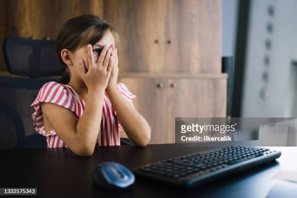 child girl using computer, reaching content that she is not allowed to. parental control concept. - content stock pictures, royalty-free photos & images