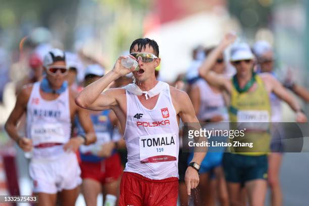 Dawid Tomala of Team Poland grabs water as he competes in the Men's 50km Race Walk Final on day fourteen of the Tokyo 2020 Olympic Games at Sapporo...