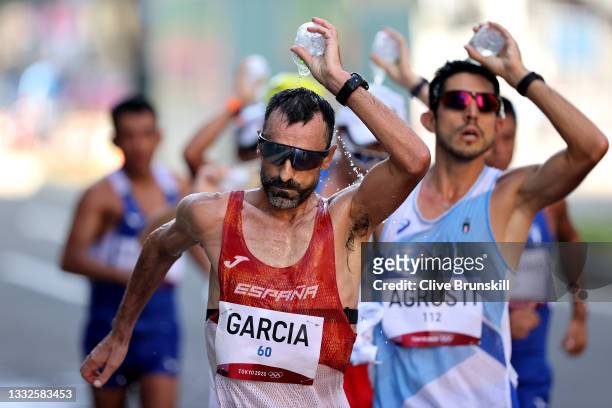 Jesus Angel Garcia of Team Spain cools off as he competes in the Men's 50km Race Walk Final on day fourteen of the Tokyo 2020 Olympic Games at...
