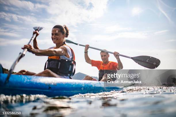 action portrait of spanish kayakers enjoying morning workout - kayaking stock pictures, royalty-free photos & images