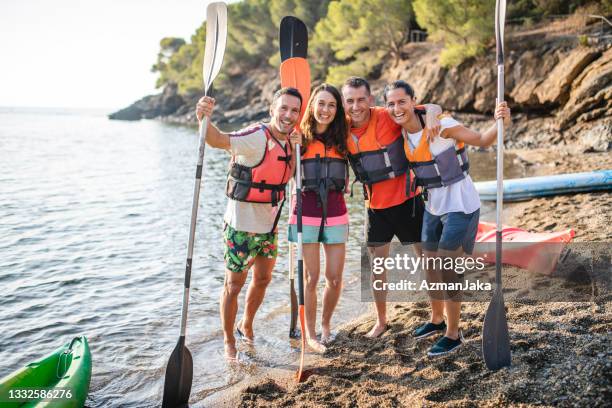 portrait of spanish kayakers with arms around each other - life jacket isolated stock pictures, royalty-free photos & images