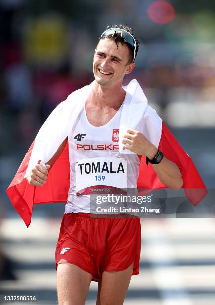 Dawid Tomala of Team Poland reacts after winning the gold medal in the Men's 50km Race Walk Final on day fourteen of the Tokyo 2020 Olympic Games at...