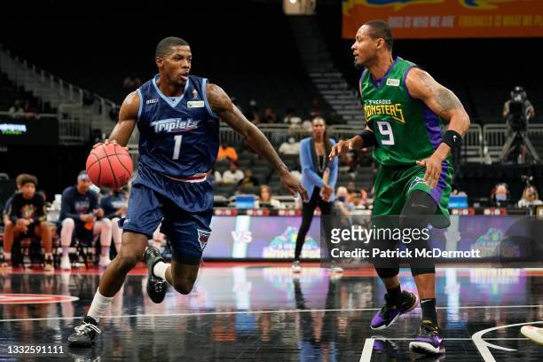 Joe Johnson of the Triplets dribbles the ball while being guarded by Rashard Lewis of the 3 Headed Monsters during BIG3 - Week Five at the Fiserv...