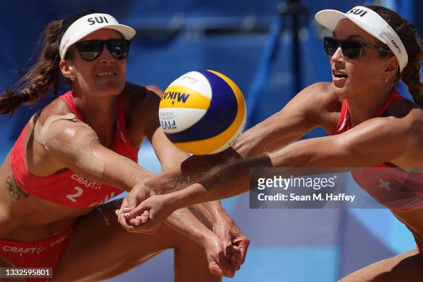 Joana Heidrich and Anouk Verge-Depre of Team Switzerland kneel to return the ball against Team Latvia during the Women's Bronze Medal Match on day...