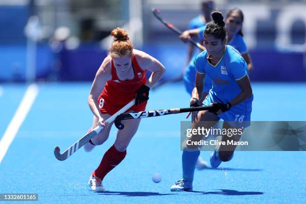 Sarah Louise Jones of Team Great Britain and Udita of Team India battle for a loose ball during the Women's Bronze medal match between Great Britain...