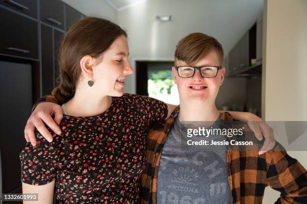 portrait of bother and sister indoors - boy has down syndrome - brothers imagens e fotografias de stock