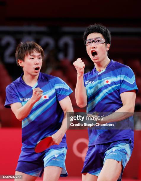 Koki Niwa and Mizutani Jun of Team Japan react during their Men's Team Bronze Medal table tennis match on day fourteen of the Tokyo 2020 Olympic...