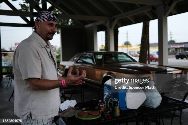 John, who said he has not yet received the Covid-19 vaccine, makes dinner for himself and his daughter at a motel on August 05, 2021 in Springfield,...