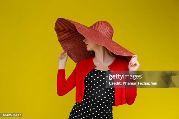 fashionable woman in black polka dot dress - wide brim stock pictures, royalty-free photos & images