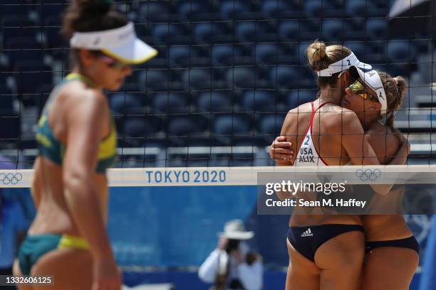 Alix Klineman and April Ross of Team United States hug while competing against Team Australia during the Women's Gold Medal Match on day fourteen of...