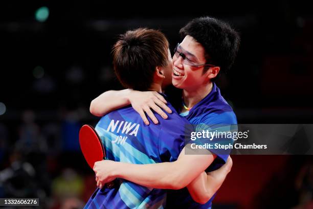 Koki Niwa and Mizutani Jun of Team Japan hug during their Men's Team Bronze Medal table tennis match on day fourteen of the Tokyo 2020 Olympic Games...