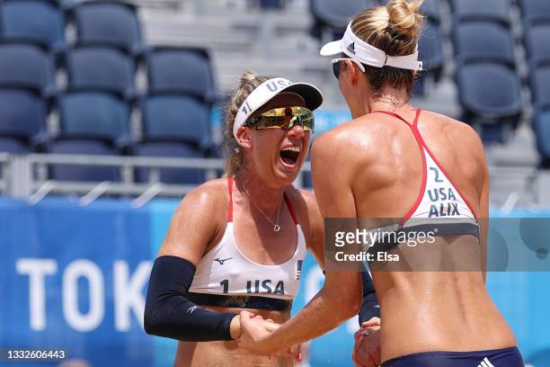 April Ross and Alix Klineman of Team United States celebrate after defeating Team Australia during the Women's Gold Medal Match on day fourteen of...