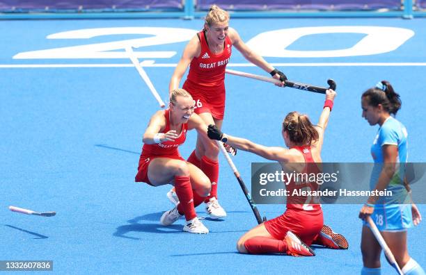 Rani of Team India looks on while Shona McCallin and Lily Owsley of Team Great Britain celebrate after winning the Women's Bronze medal match between...