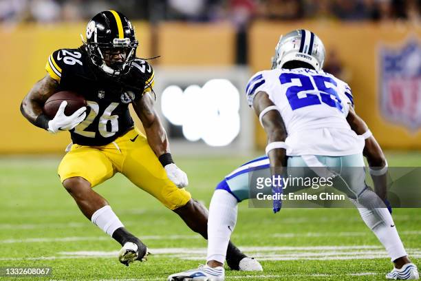Anthony McFarland of the Pittsburgh Steelers runs the ball past Steven Parker of the Dallas Cowboys in the second half during the 2021 NFL preseason...
