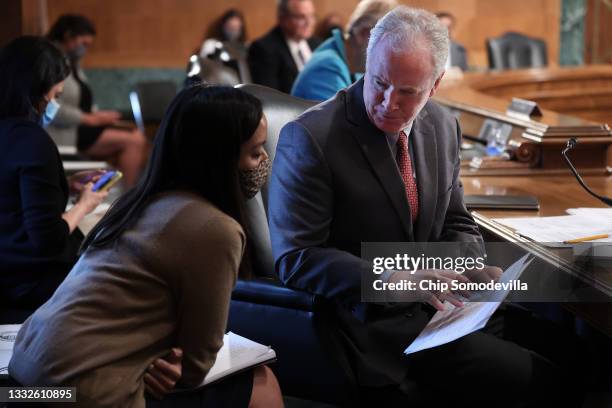 Sen. Chris Van Hollen talks with a staff member during a Senate Homeland Security and Governmental Affairs Committee confirmation hearing in the...