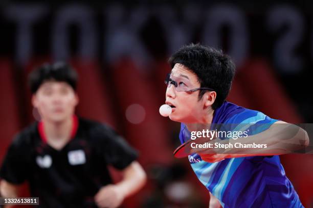 Mizutani Jun of Team Japan in action during his Men's Team Bronze Medal table tennis match on day fourteen of the Tokyo 2020 Olympic Games at Tokyo...