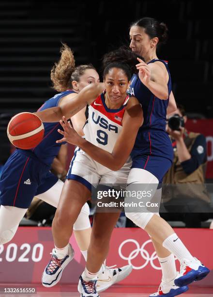 Ja Wilson of Team United States drives to the basket against Jelena Brooks of Team Serbia during the first half of a Women's Basketball Semifinals...