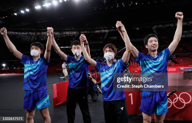 Team Japan players Harimoto Tomokazu , Koki Niwa , Mizutani Jun , and coach Yosuke Kurashima celebrate after winning their Men's Team Bronze Medal...