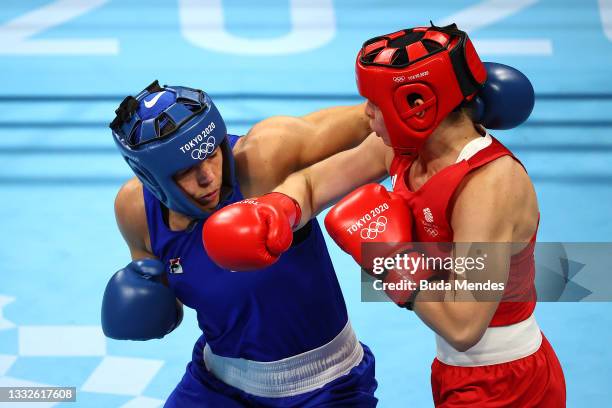 Lauren Price of Team Great Britain exchanges punches with Nouchka Fontijn of Team Netherlands during the Women's Middle Semifinal 1 on day fourteen...