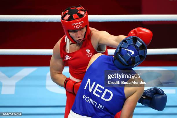 Lauren Price of Team Great Britain exchanges punches with Nouchka Fontijn of Team Netherlands during the Women's Middle Semifinal 1 on day fourteen...