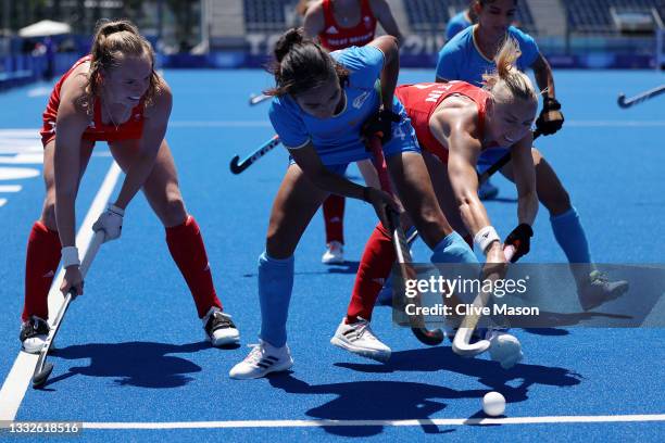 Monika of Team India and Hannah Martin of Team Great Britain battle for a loose ball during the Women's Bronze medal match between Great Britain and...