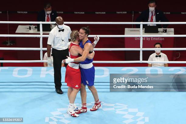Lauren Price of Team Great Britain and Nouchka Fontijn of Team Netherlands embrace after their bout during the Women's Middle Semifinal 1 on day...