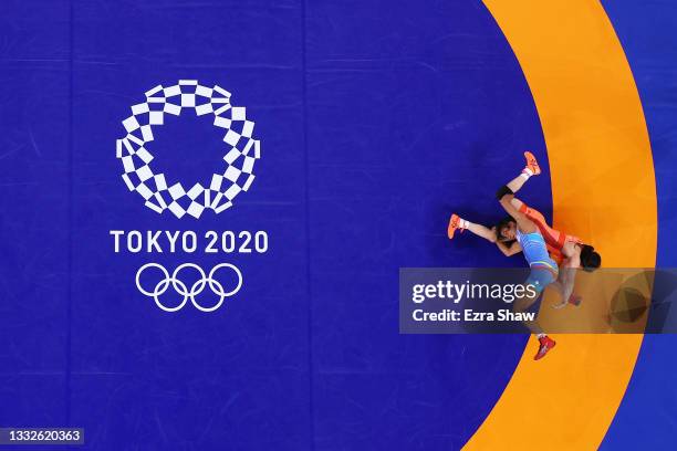 Yui Susaki of Team Japan competes against Lucia Yamileth Yepez Guzman of Team Ecuador during the Women's Freestyle 50kg Quarter Final on day fourteen...