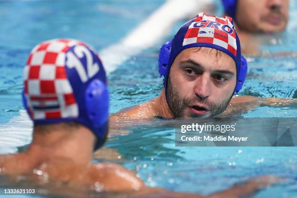 Paulo Obradovic of Team Croatia talks to Javier Garcia Gadea during the Men's Classification 5th-8th match between Montenegro and Croatia on day...