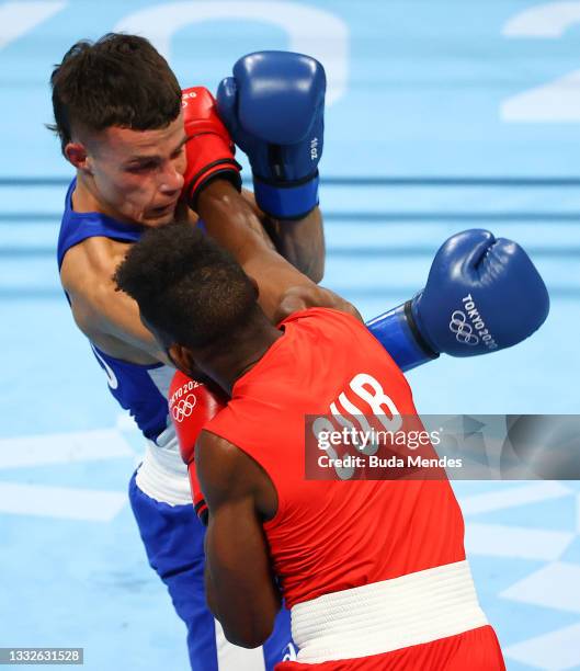 Andy Cruz of Team Cuba exchanges punches with Harry Garside of Team Australia during the Men's Light Semifinal 2 on day fourteen of the Tokyo 2020...