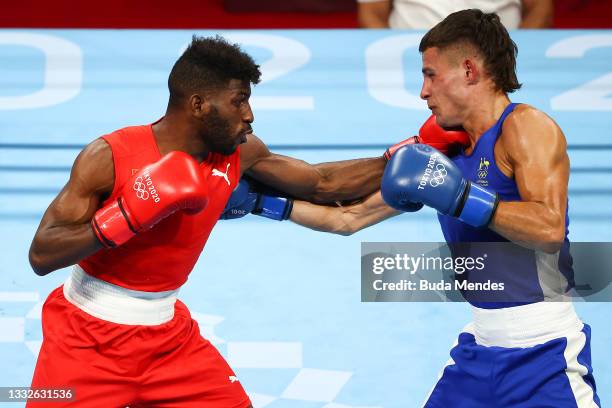 Andy Cruz of Team Cuba exchanges punches with Harry Garside of Team Australia during the Men's Light Semifinal 2 on day fourteen of the Tokyo 2020...