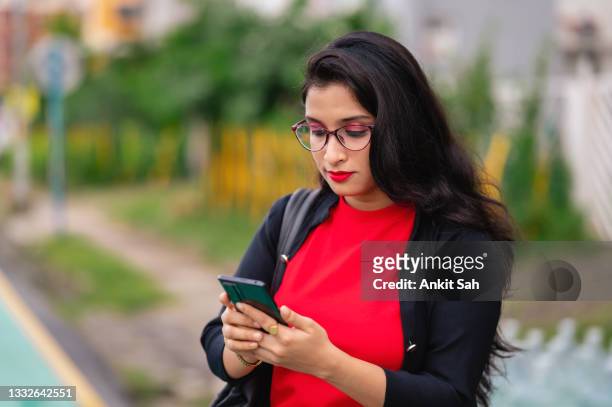 young indian girl using smartphone - beautiful college girls stock pictures, royalty-free photos & images