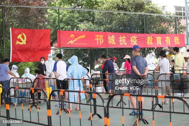 People wait in a line for nucleic acid testing at a temporary Covid-19 testing center during a citywide COVID-19 nucleic acid testing campaign on...