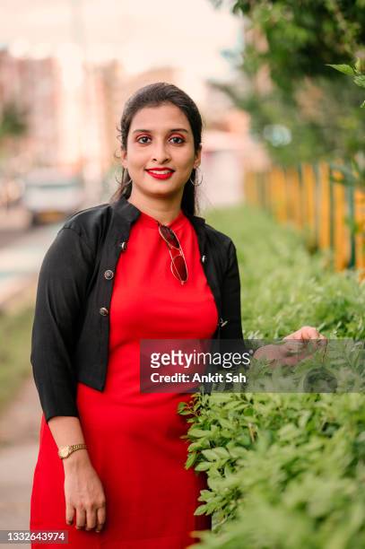 portrait of young girl with green plant in nature park. - beautiful college girls stock pictures, royalty-free photos & images