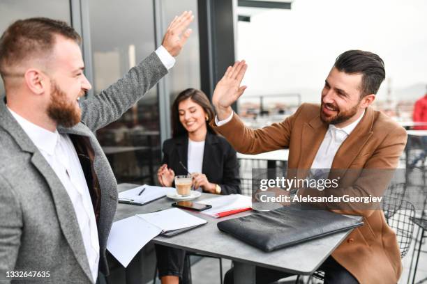 high five by successful business partners on coffee meeting with secretary - elbow bump stock pictures, royalty-free photos & images