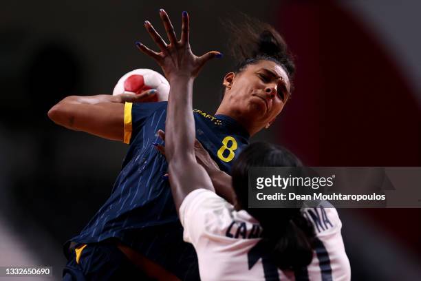 Jamina Roberts of Team Sweden shoots and scores a goal while under pressure from Grace Zaadi Deuna of Team France during the Women's Semifinal...
