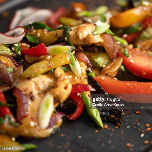stir-fried oriental dish, vegetables with scallion or shallot and sesame seeds. close-up shot. soft focus - stir frying european stock pictures, royalty-free photos & images