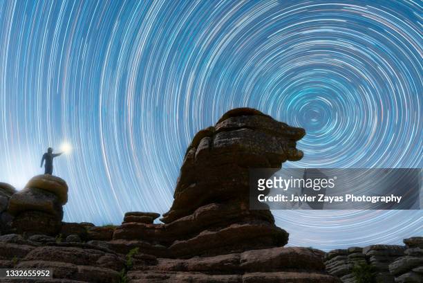 silhouette man standing on rock formation under the stars - paraje natural torcal de antequera stock pictures, royalty-free photos & images