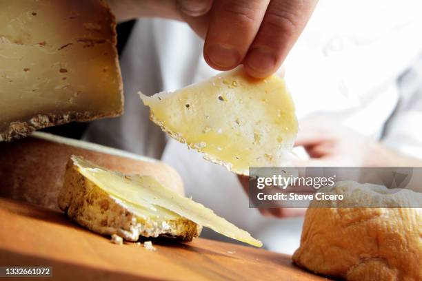 chef removing fresh sliced hard italian pecorino romano cheese - sheeps milk cheese stock pictures, royalty-free photos & images