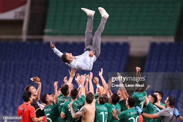 Jaime Lozano, Head Coach of Mexico is thrown in the air by his players following victory in the Men's Bronze Medal Match between Mexico and Japan on...