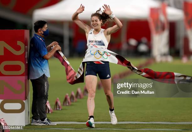 Kate French of Team Great Britain crosses the line to win gold in the Laser Run during the Women's Modern Pentathlon on day fourteen of the Tokyo...