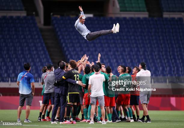 Jaime Lozano, Head Coach of Mexico is thrown in the air by his players following victory in the Men's Bronze Medal Match between Mexico and Japan on...