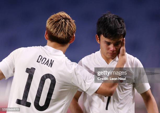 Takefusa Kubo of Team Japan looks dejected as he is consoled by Ritsu Doan following defeat in the Men's Bronze Medal Match between Mexico and Japan...