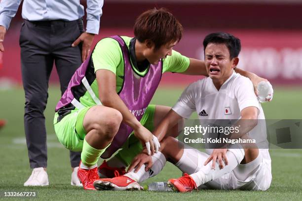 Takefusa Kubo of Team Japan looks dejected as he is consoled by Keisuke Osako of Team Japan following defeat in the Men's Bronze Medal Match between...