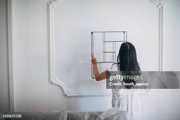 Putting Something In 558 Woman Putting Things On Shelf Stock Photos, High-Res Pictures, and ...