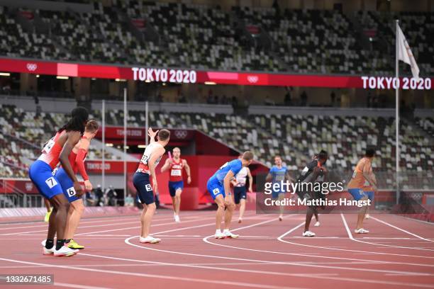 The athletes look to receive the baton in the Men's 4 x 400m Relay heats on day fourteen of the Tokyo 2020 Olympic Games at Olympic Stadium on August...