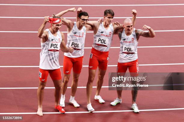 Dariusz Kowaluk, Karol Zalewski, Jakub Krzewina and Kajetan Duszynski of Team Poland pose for a photo after the Men's 4 x 400m Relay heats on day...